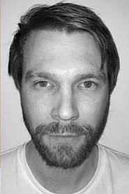 Michael Homick as Kwei (Suit)